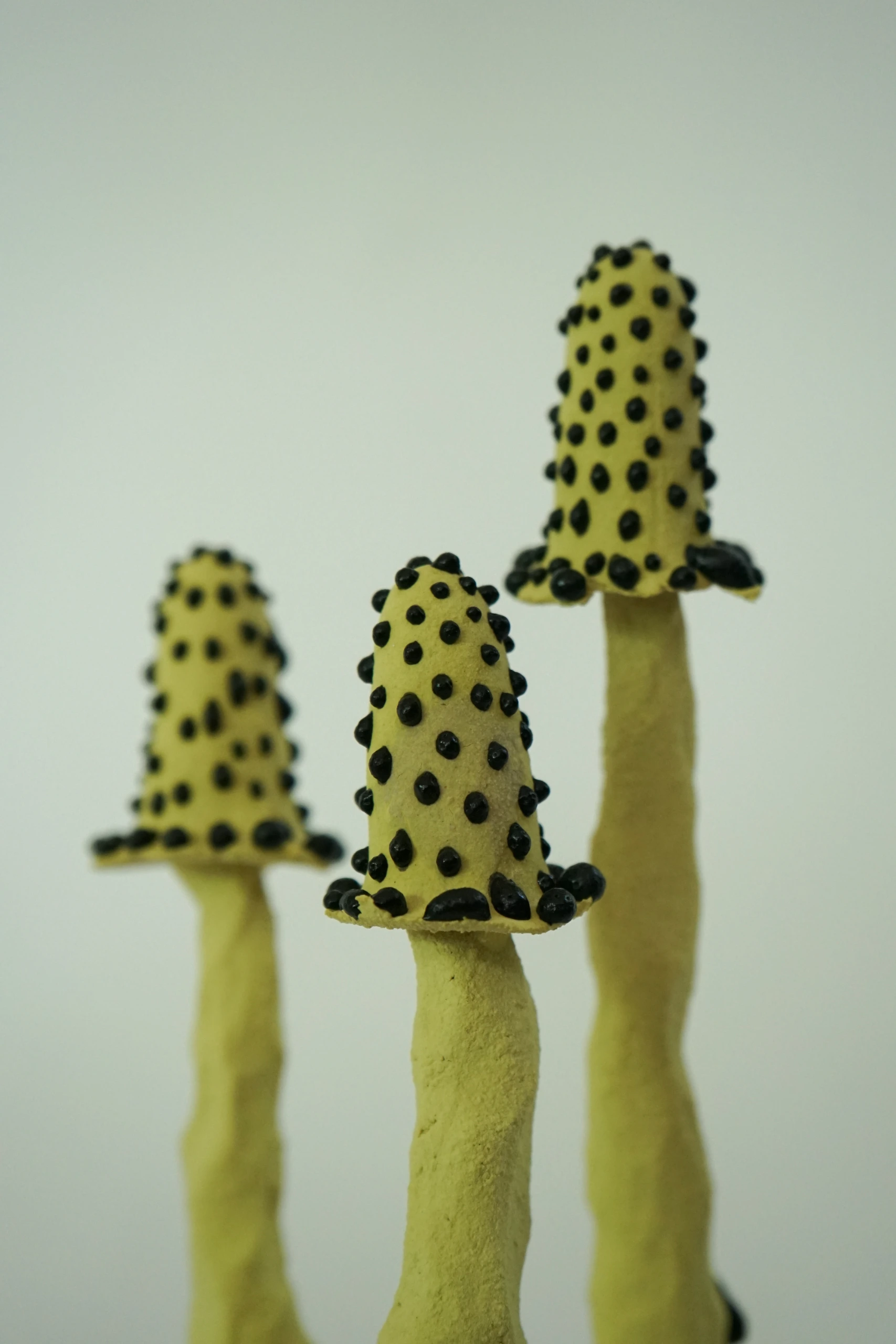 Yellow Black Inkcap (2026), ceramic sculpture by Sjors Driessen with a slender black mushroom-like form finished with textured yellow glaze.