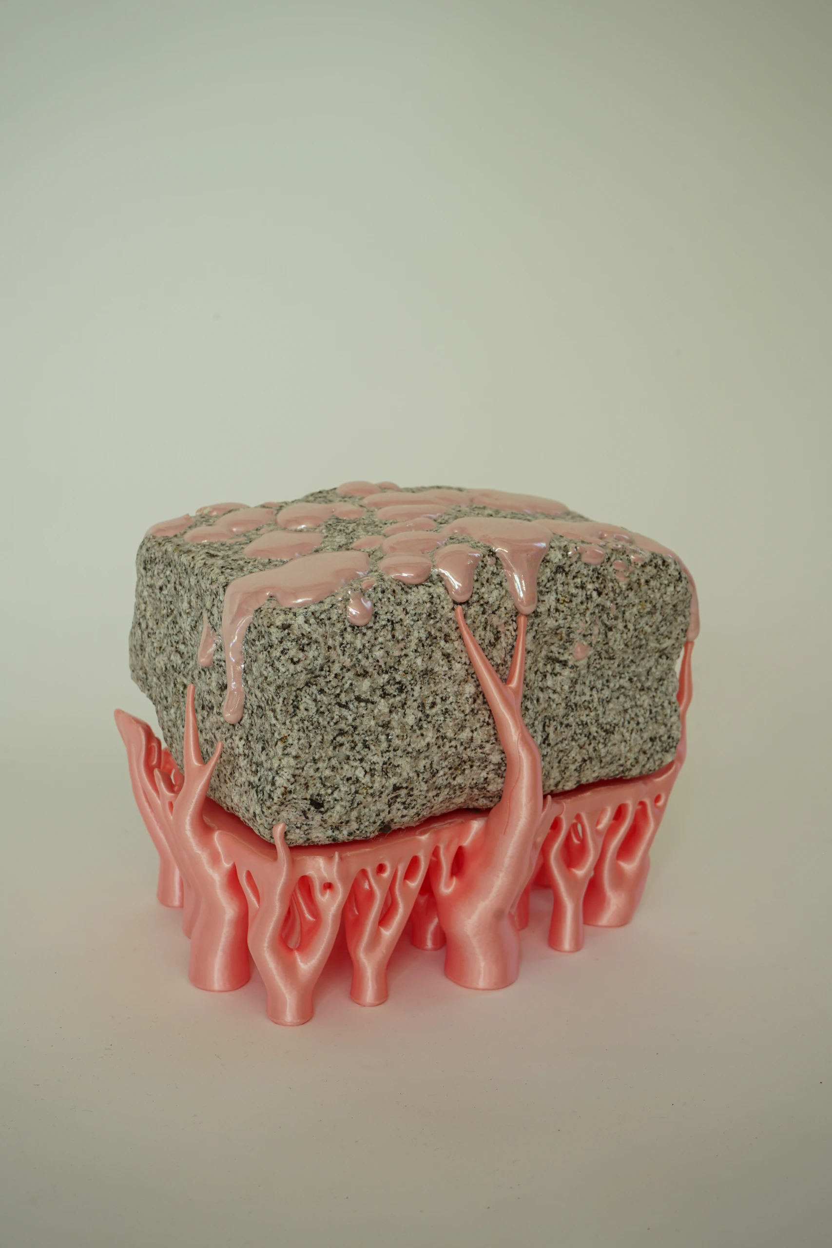 Pink Hyphae (2026), sculpture by Sjors Driessen combining granite with pink glaze and branching pink hyphae-like structures that appear to support and grow around the stone.