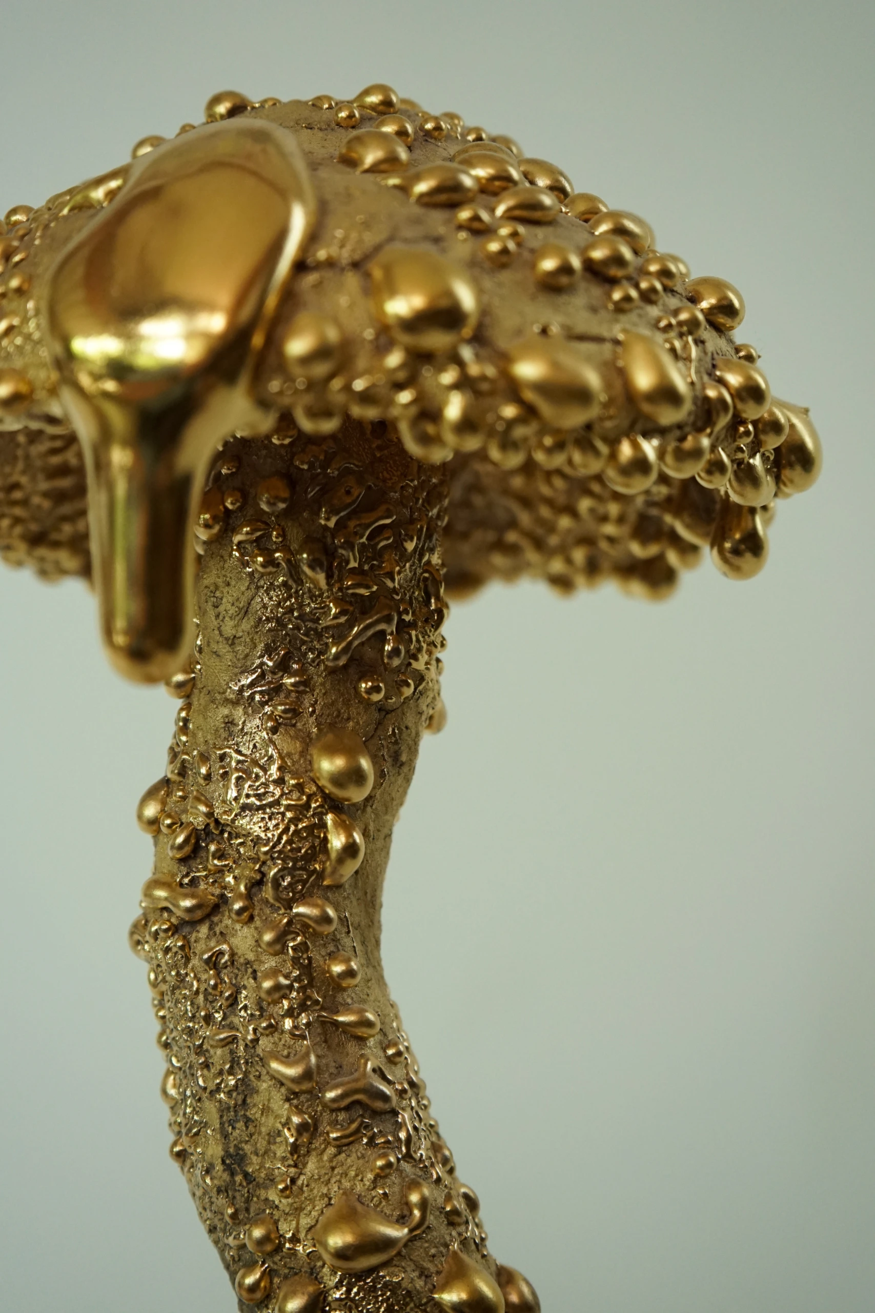 Gold Inkcap (2026), ceramic sculpture by Sjors Driessen with an elongated organic mushroom form covered in textured glaze and reflective gold lustre.