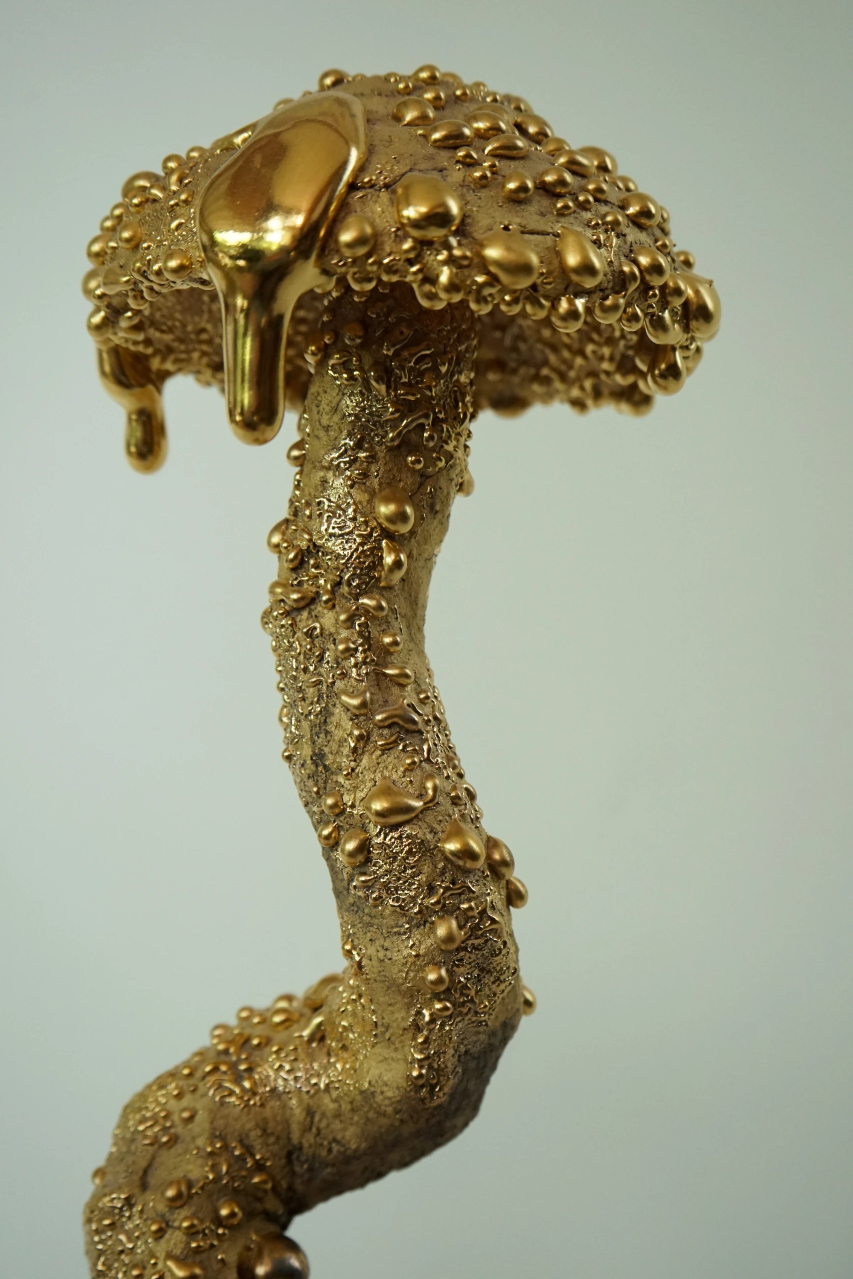Gold Inkcap (2026), ceramic sculpture by Sjors Driessen with an elongated organic mushroom form covered in textured glaze and reflective gold lustre.