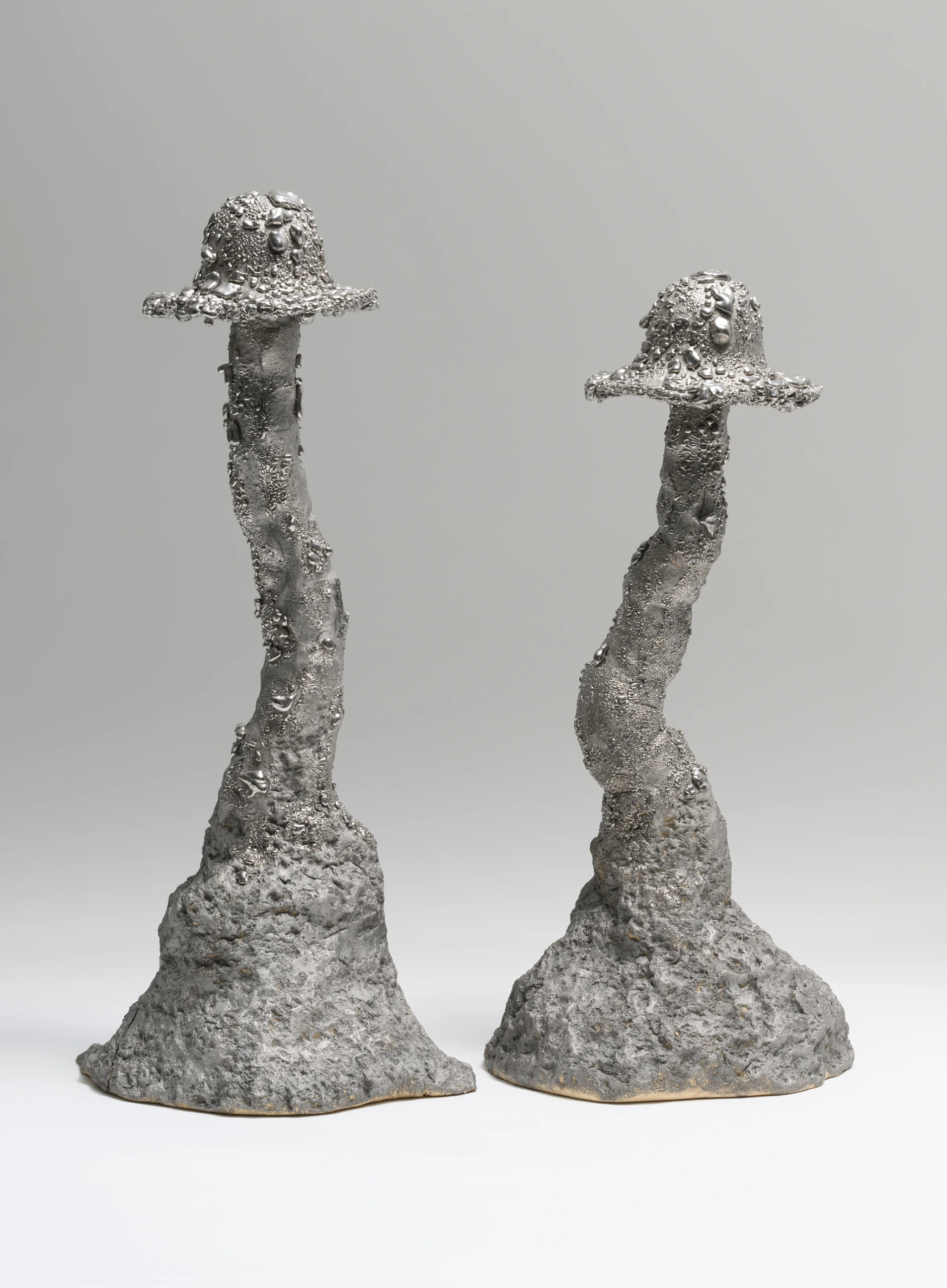Platina Roundhead (2024), ceramic sculptures by Sjors Driessen with two tall silver-toned mushroom forms and rough textured surfaces.