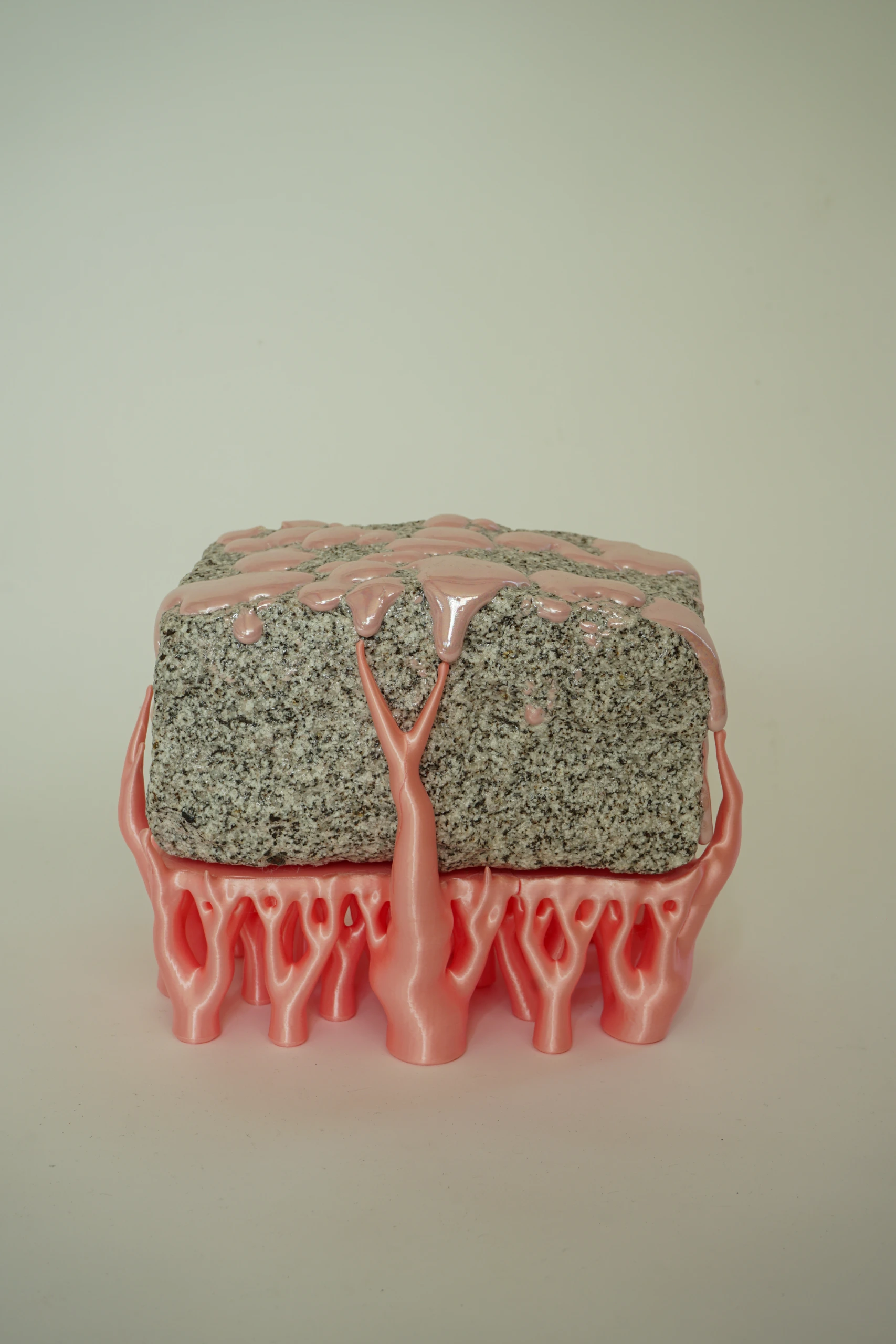 Pink Hyphae (2026), sculpture by Sjors Driessen combining granite with pink glaze and branching pink hyphae-like structures that appear to support and grow around the stone.