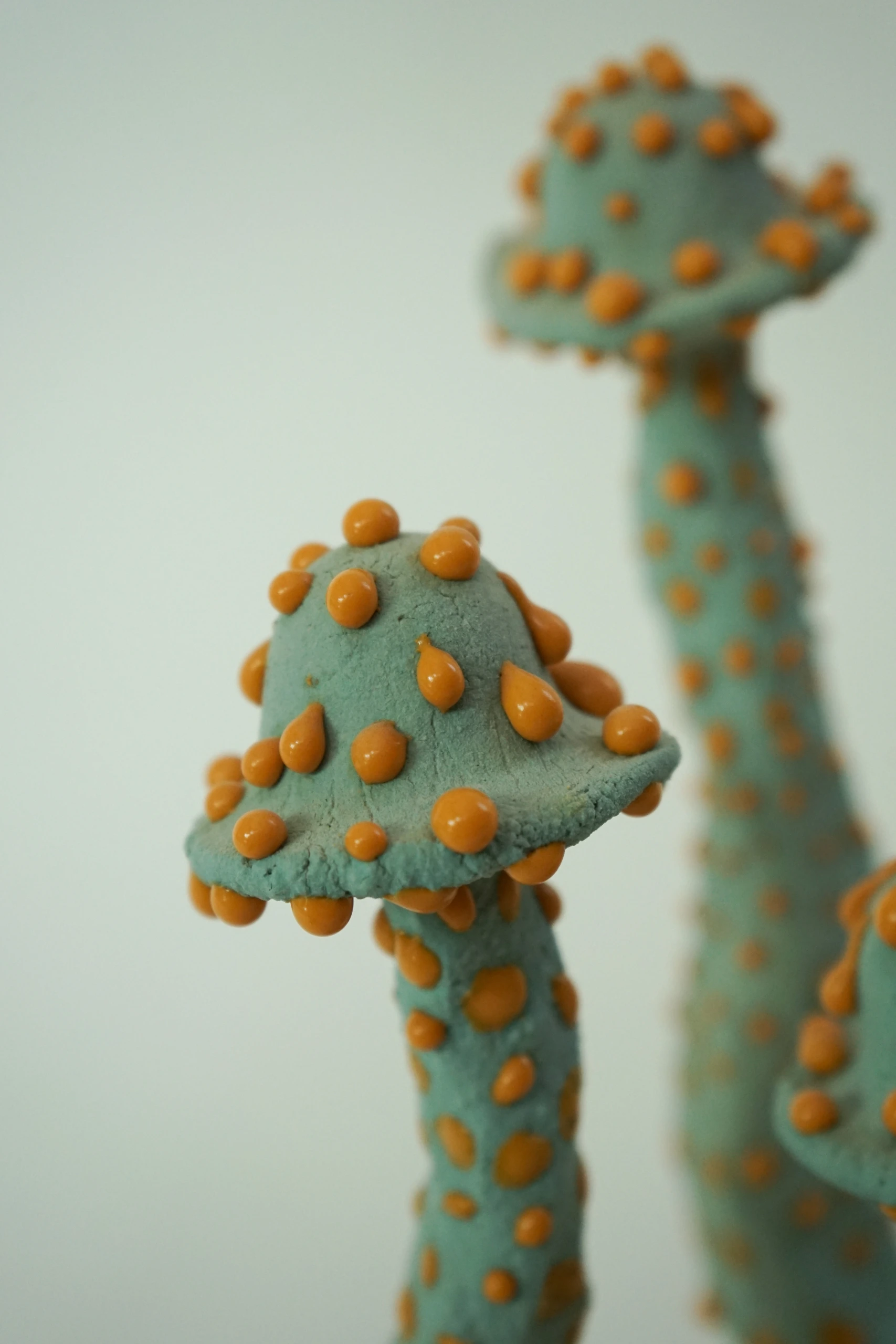 Orange Blue Roundcap (2026), ceramic sculpture by Sjors Driessen with a rounded orange mushroom-like form finished with textured blue glaze.
