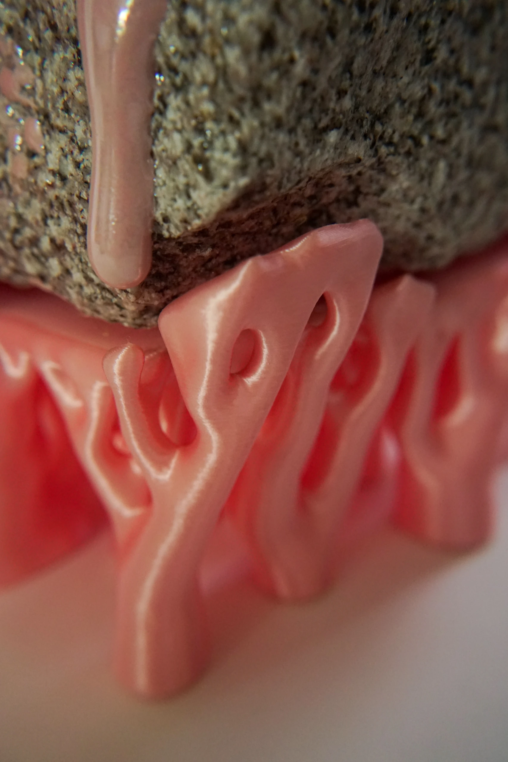 Pink Hyphae (2026), sculpture by Sjors Driessen combining granite with pink glaze and branching pink hyphae-like structures that appear to support and grow around the stone.