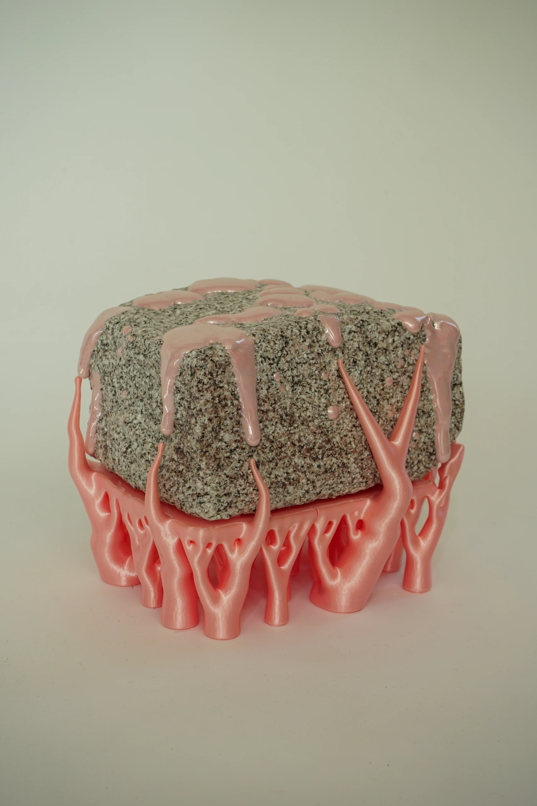 Pink Hyphae (2026), sculpture by Sjors Driessen combining granite with pink glaze and branching pink hyphae-like structures that appear to support and grow around the stone.