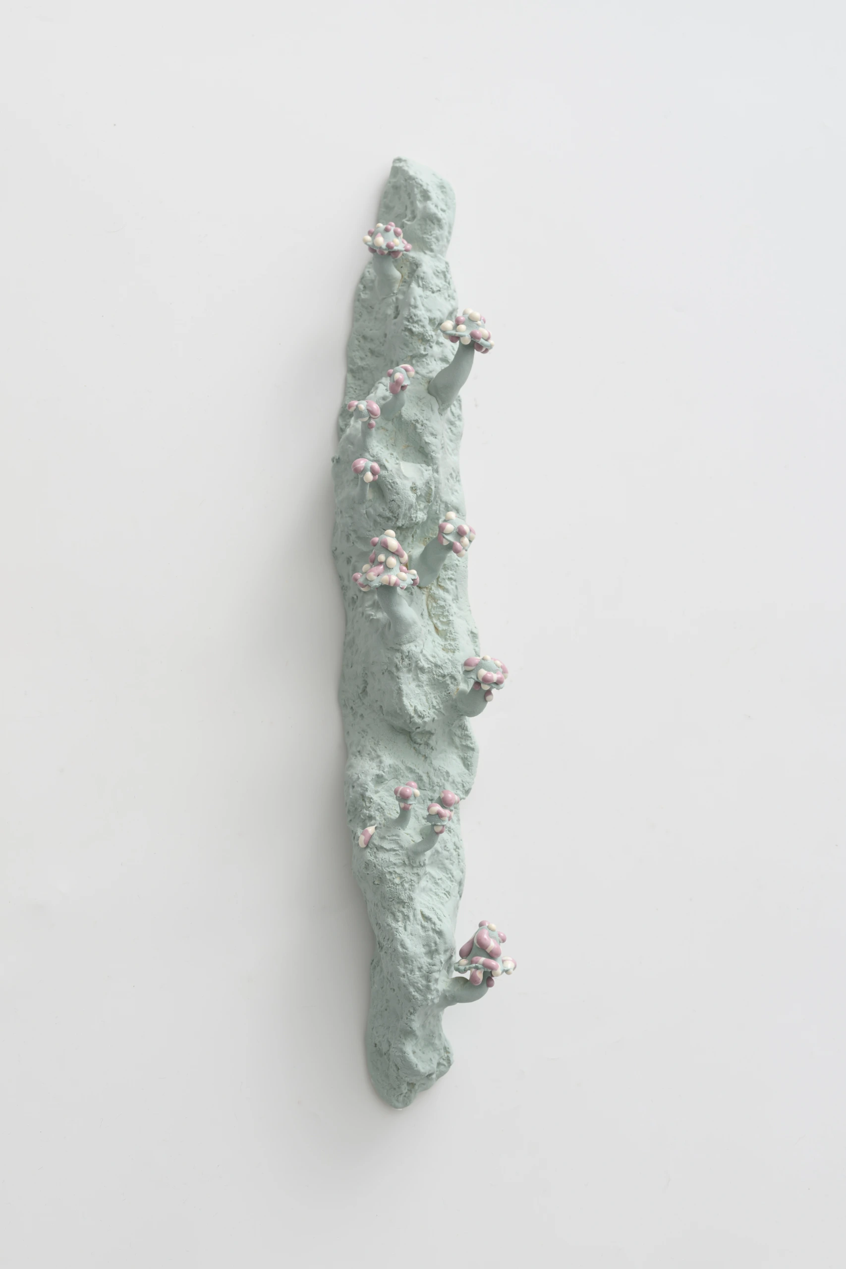 Small Blue/Purple Inkcaps (2024), ceramic wall sculpture by Sjors Driessen with small pale purple fungal growths on a light blue organic form.