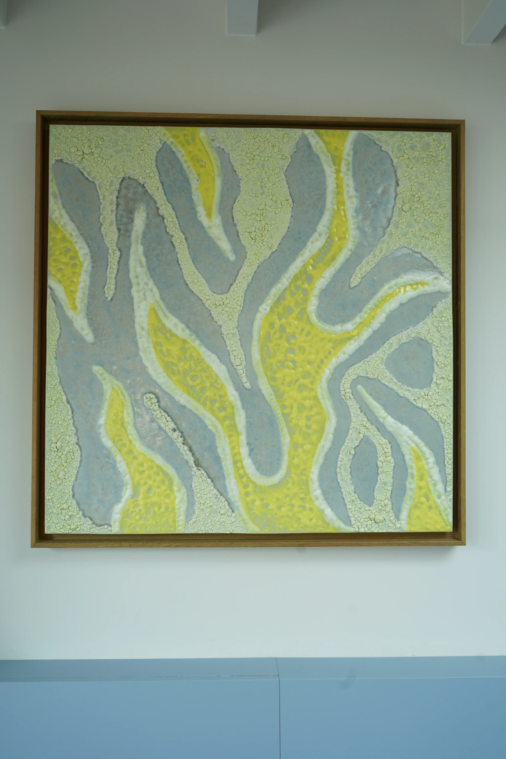 YellowSeas (2025), ceramic wall sculpture by Sjors Driessen combining glazed ceramic elements with American oak in a 93 × 93 cm composition.