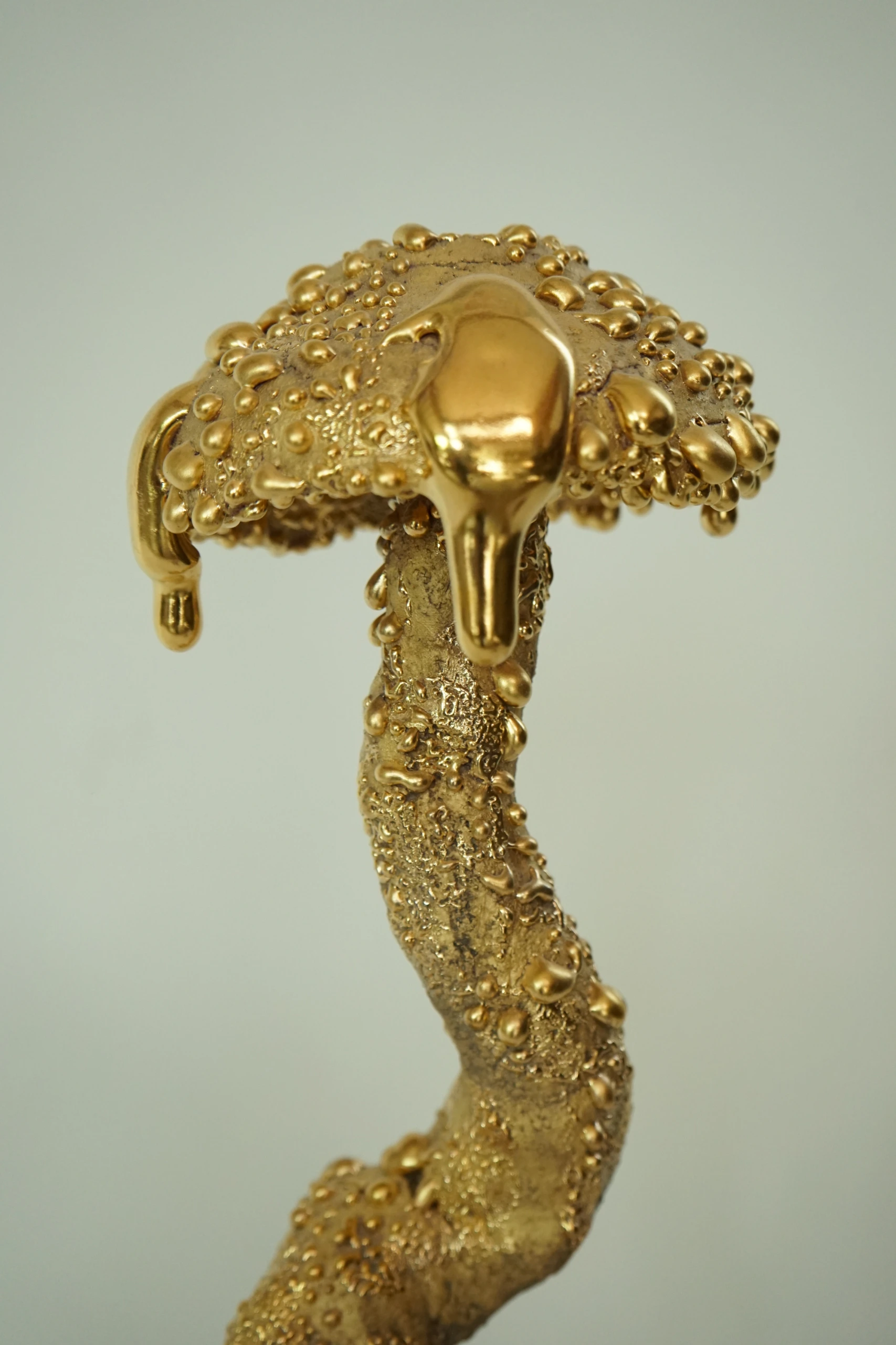 Gold Inkcap (2026), ceramic sculpture by Sjors Driessen with an elongated organic mushroom form covered in textured glaze and reflective gold lustre.