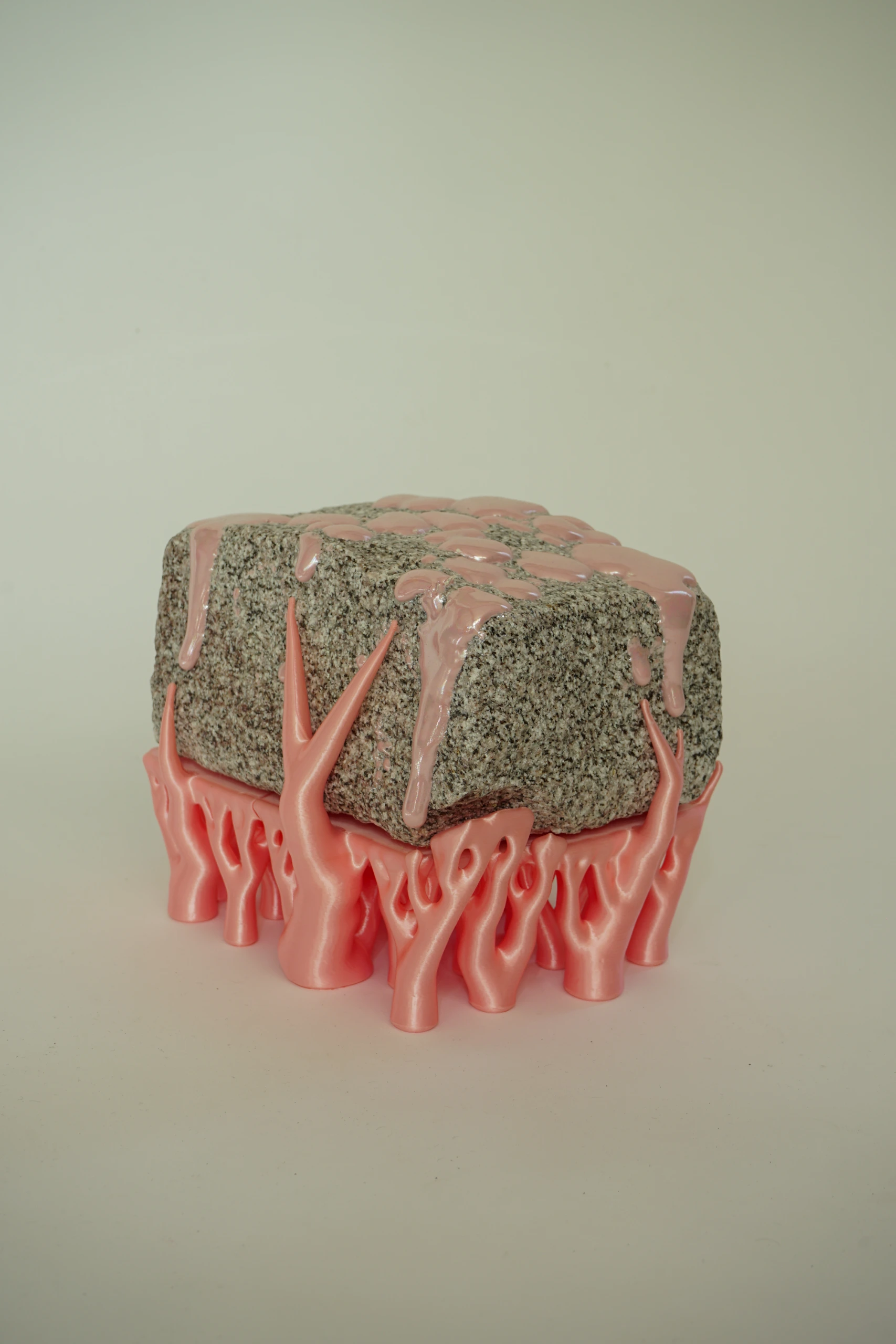 Pink Hyphae (2026), sculpture by Sjors Driessen combining granite with pink glaze and branching pink hyphae-like structures that appear to support and grow around the stone.